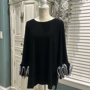 Ali Miles black stretch top with white satin-trimmed ruffled cuffs. Sizes is XL